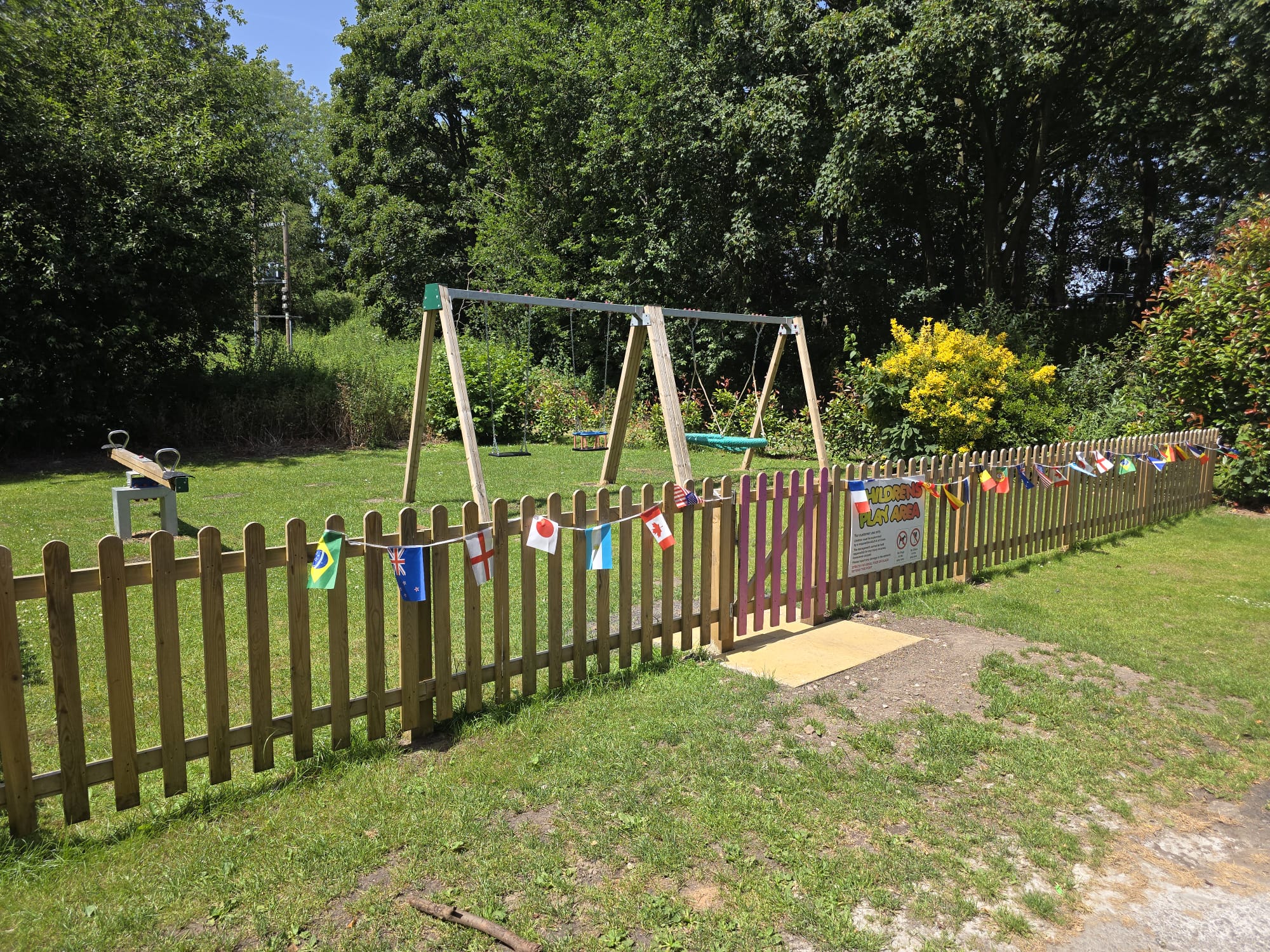 Children's play area with swings and see-saw